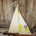 Driftwood sailboat made from driftwood found on the beaches of Long Island. Sails made of vintage fabric. Measures 25" w x 25" h