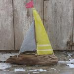 Driftwood sailboat made from driftwood found on the beaches of Long Island. Sails made of vintage fabric. Measures 13" w 14" h