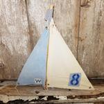 Driftwood sailboat made from driftwood found on the beaches of Long Island. Sails made of vintage fabric. Measures 25" w x 18" h