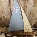 Driftwood sailboat made from driftwood found on the beaches of Long Island. Sails made of vintage fabric. Measures 22" w x 23" h