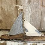Driftwood sailboat made from driftwood found on the beaches of Long Island. Sails made of vintage fabric. Measures 20" w x 12" h